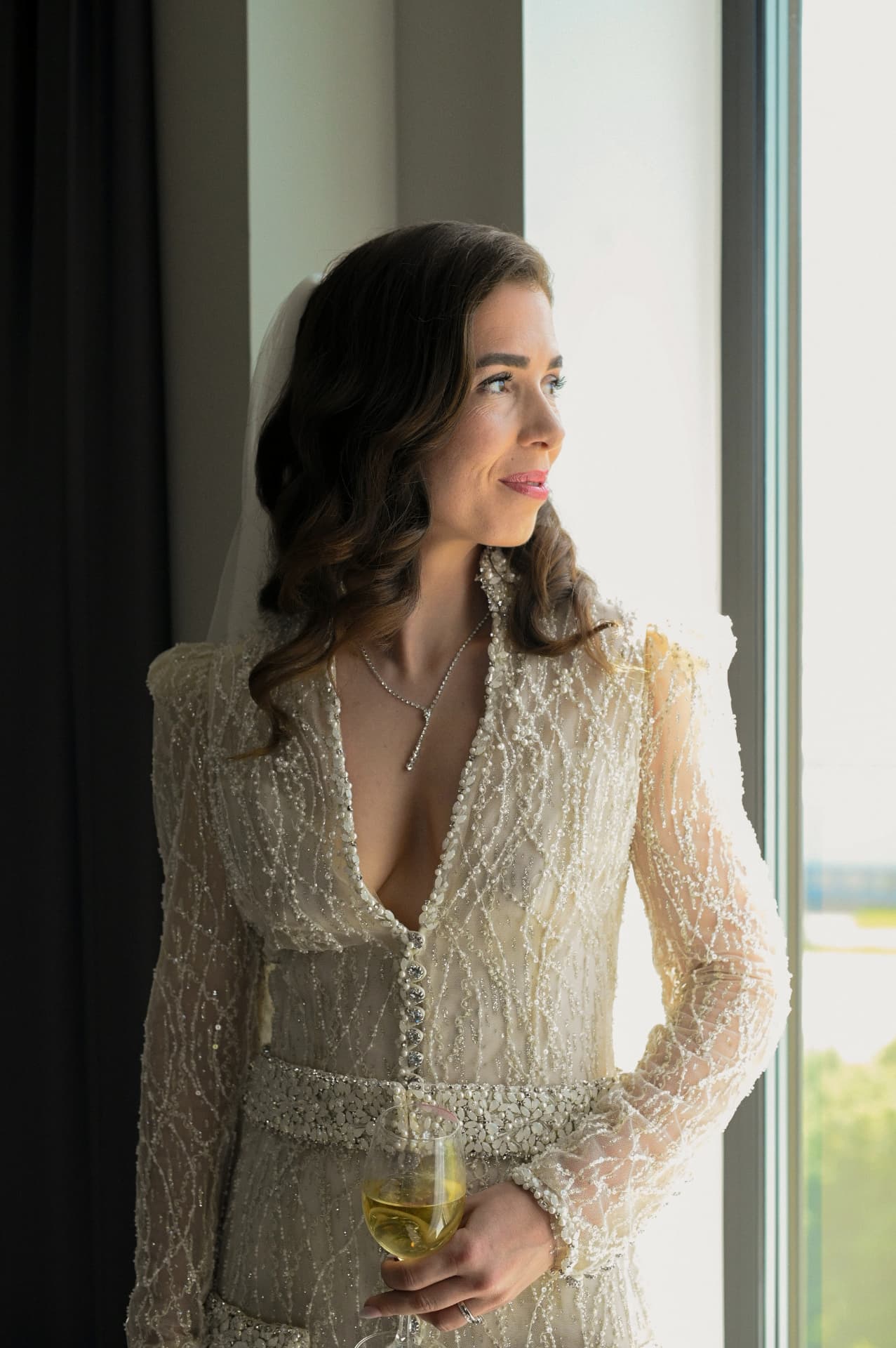 Bride by the window before the ceremony