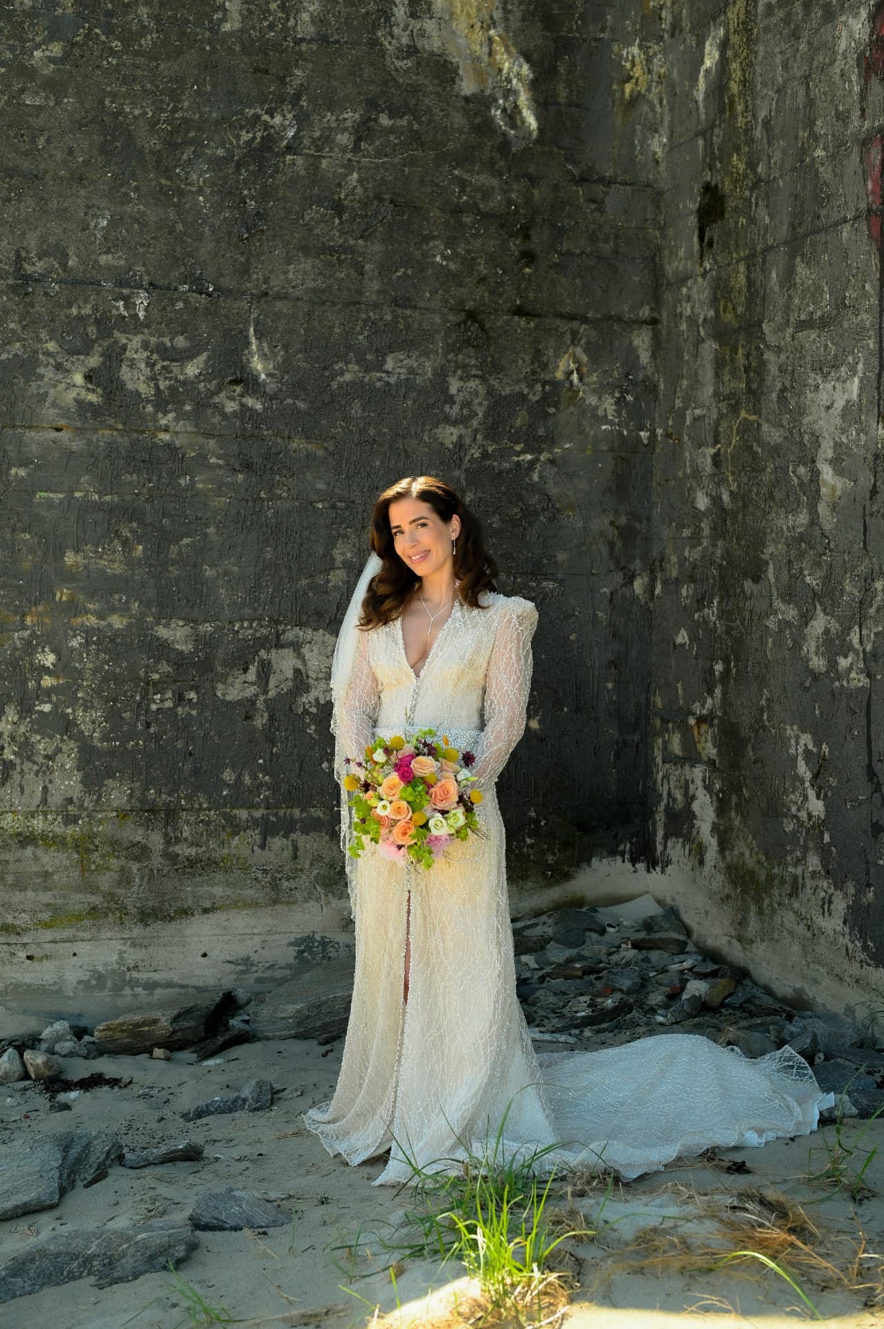 Full length portrait of the bride against the rock wall