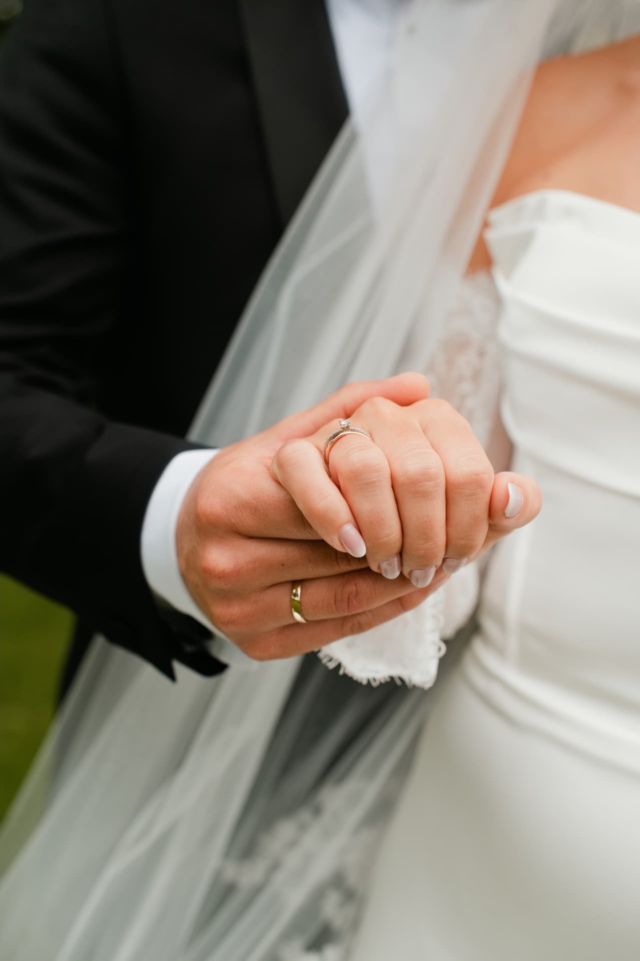 Close detail of the couple's hands and rings