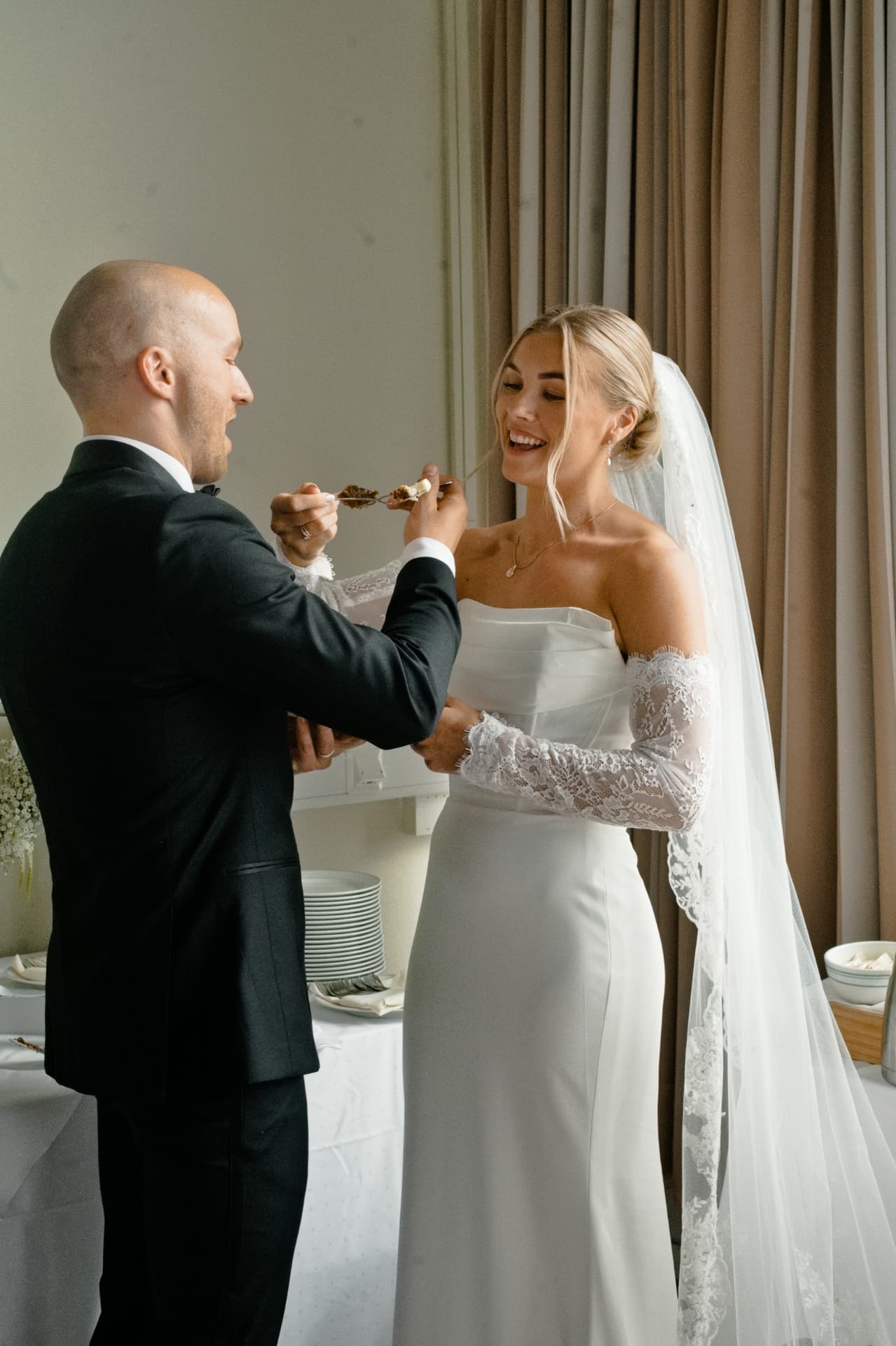 Couple sharing the first bite of cake