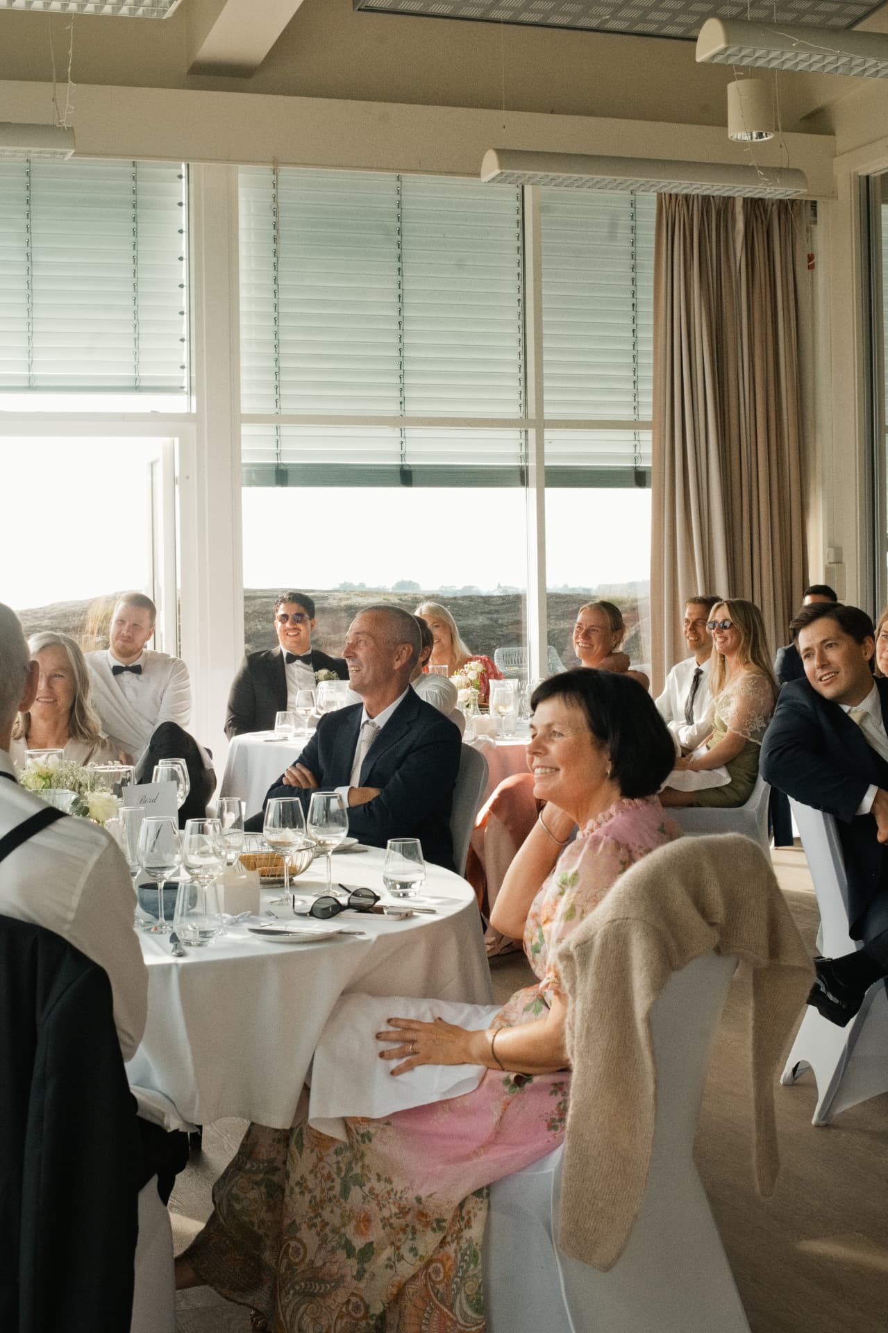 Guests laughing during the seaside reception