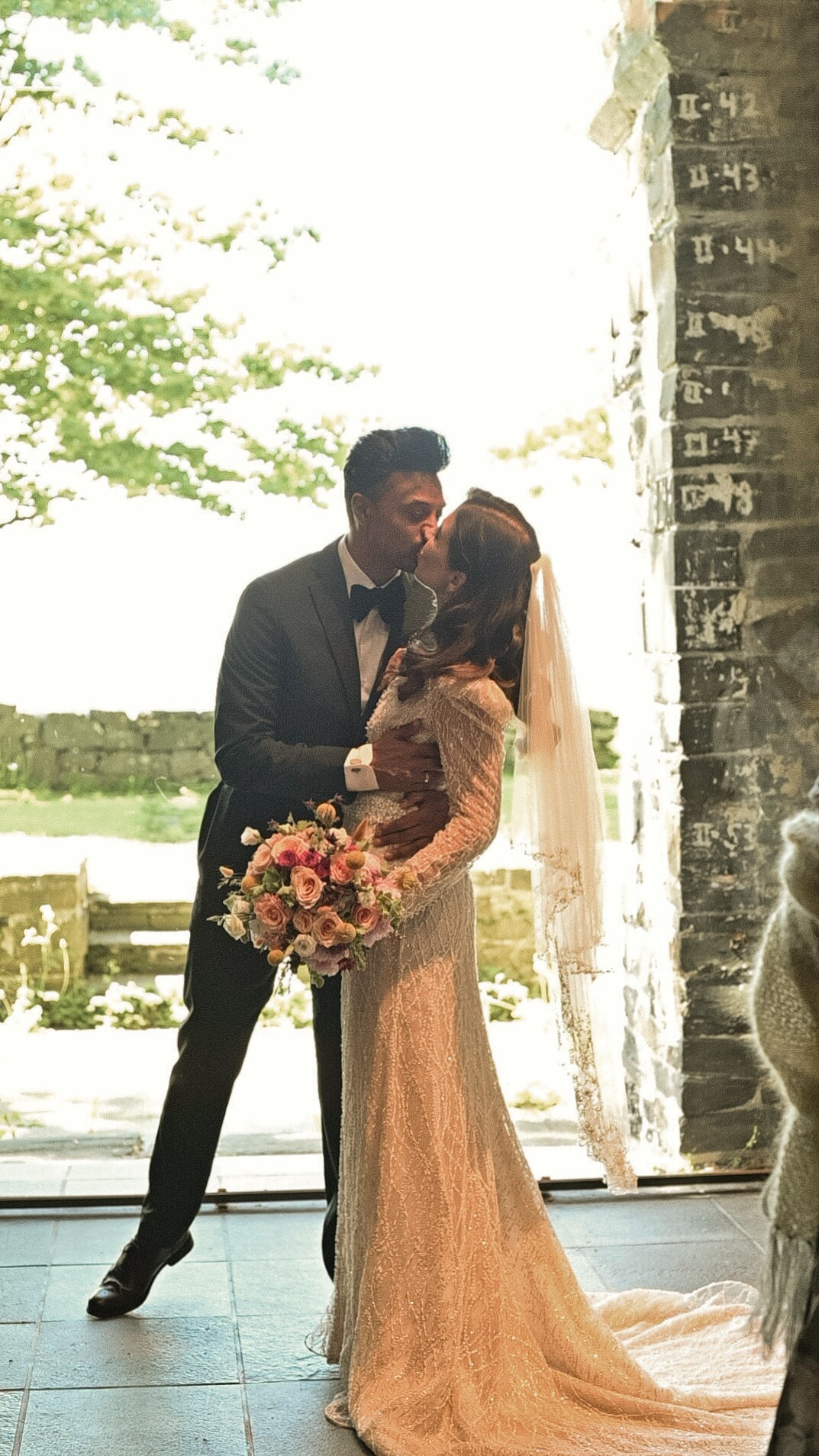 Couple sharing a kiss at the church doorway