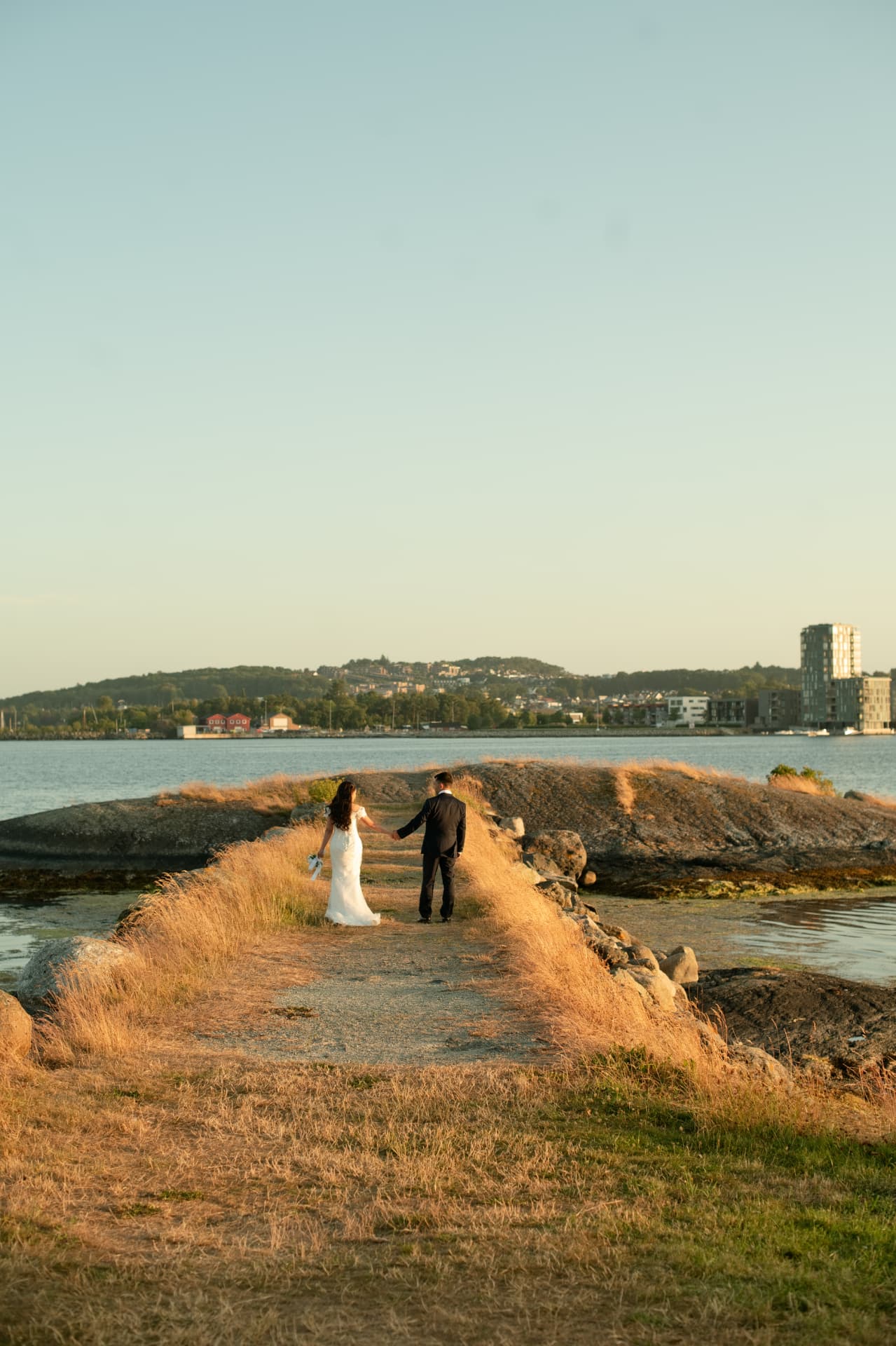 Couple hand in hand on the path between the rocks