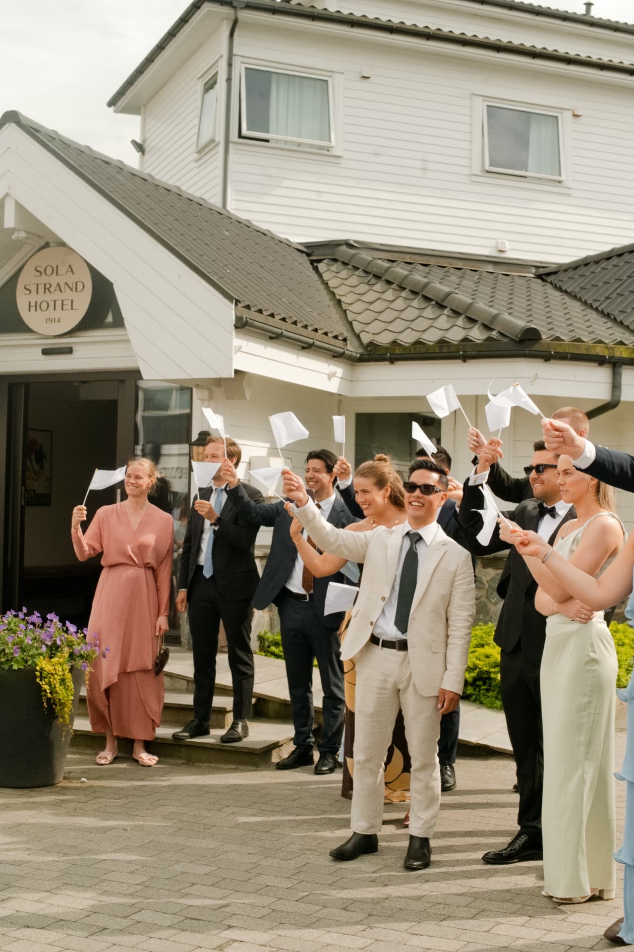 Guests waving flags as the couple arrive