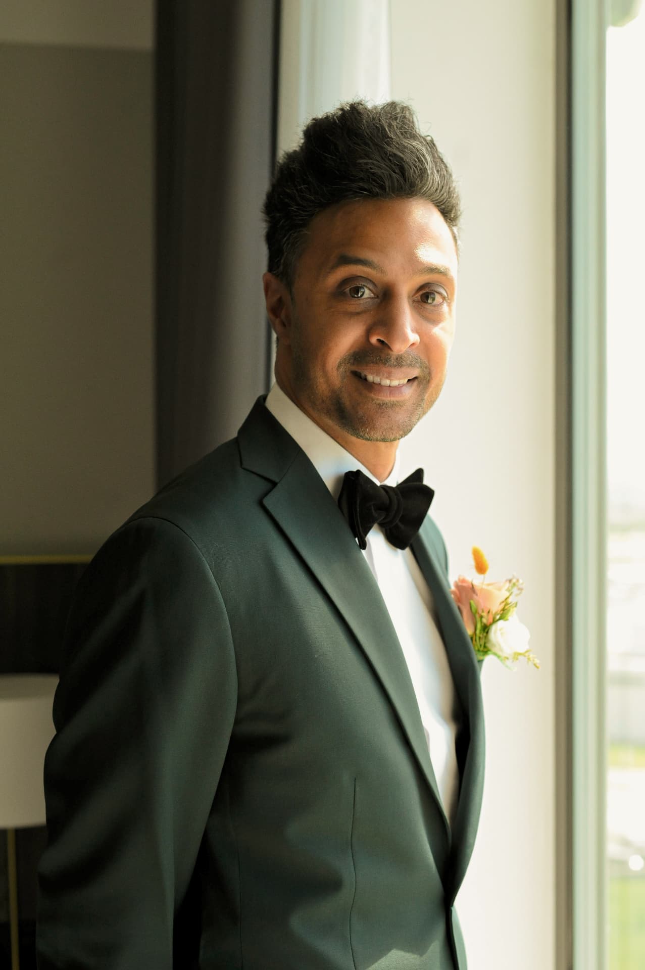 Groom in a deep green tuxedo