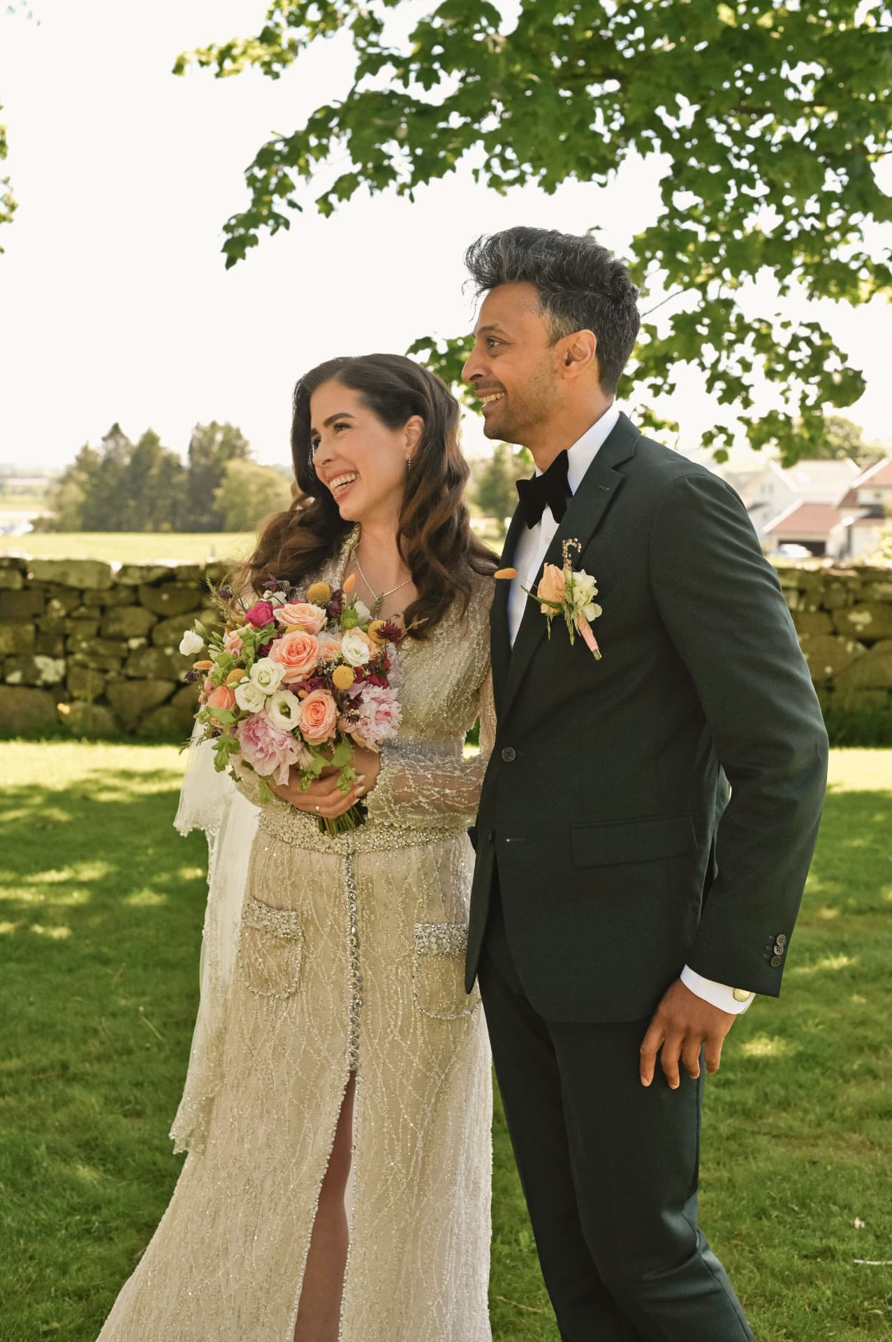 Couple walking on the grass after the ceremony