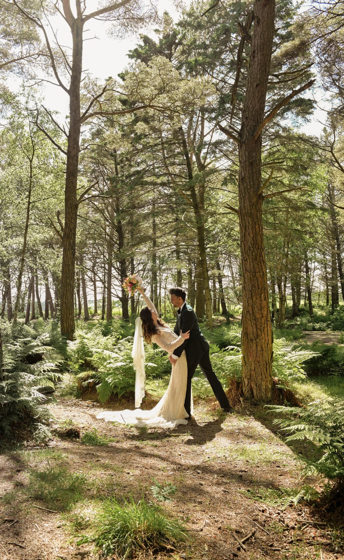 Couple dancing in a forest clearing