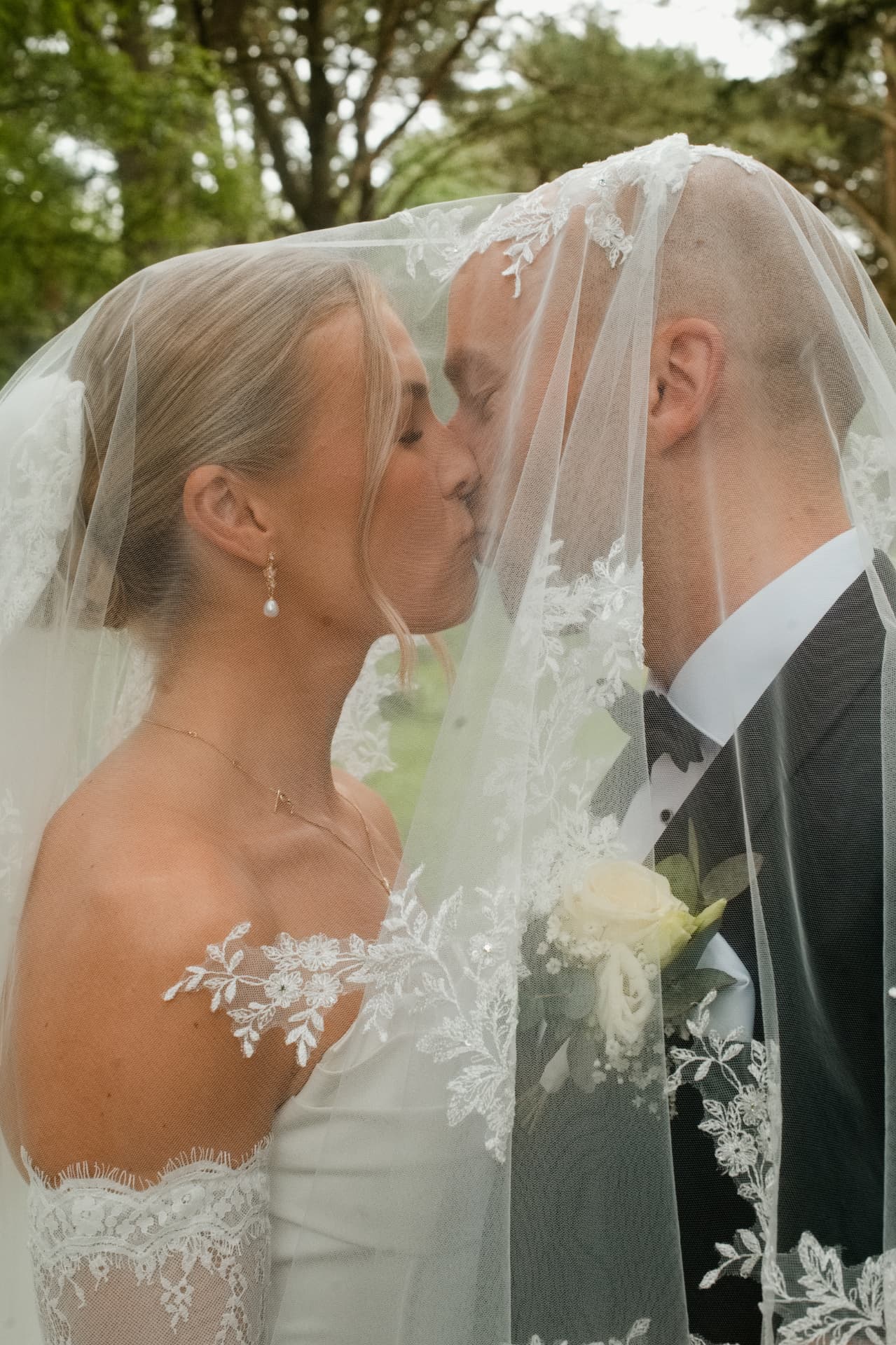 Couple kissing beneath the veil